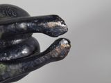 a statue of a hand holding a ball in it ' s palm