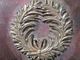 a close up of a wooden table with a decorative design