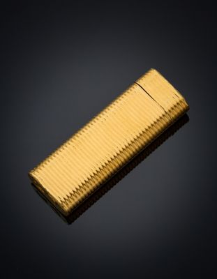 a close up of a gold lighter on a black background