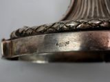 a close up of a silver plate on a table