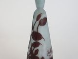 a glass vase with a brown and white design on it
