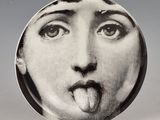 a plate with a picture of a woman sticking out her tongue