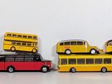 a lot of toy buses that are on top of each other