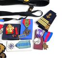many medals and medals laid out on a white surface