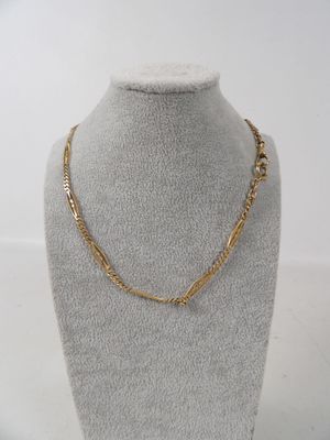 a gold chain necklace on a mannequin display with a white background
