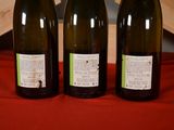 three bottles of wine sitting next to each other on a table