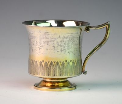 a silver cup that is sitting on a table