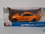 an orange toy car in a box on a table