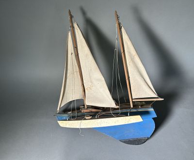 a wooden model of a sailboat on display