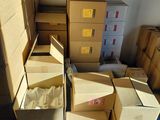 many boxes stacked on top of each other in a room
