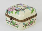 a small white box with a floral design on it