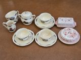 a table that has a bunch of cups and saucers on it