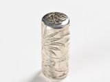a close up of a silver object on a white surface