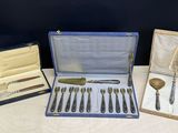 several different types of silverware are in a case on a table