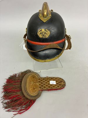 two helmets and a brush are on display on a white surface