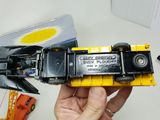 a person holding a toy truck in their hand