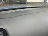 dashboard of a car in a parking lot with a car in the background