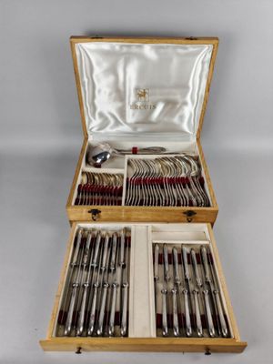 a wooden box with silverware in it on a table