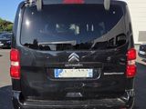 a small black van parked in a parking lot
