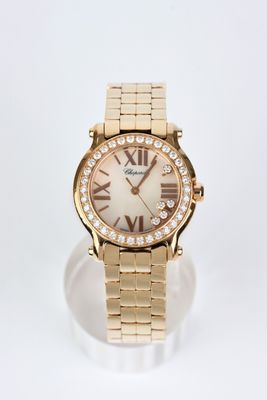 a close up of a gold watch with roman numerals on the face