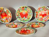 several plates with designs on them are sitting on a table