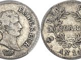 une pièce d'argent sur laquelle figurent une couronne et un couronne de laurier