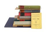 several books stacked on top of each other on a table