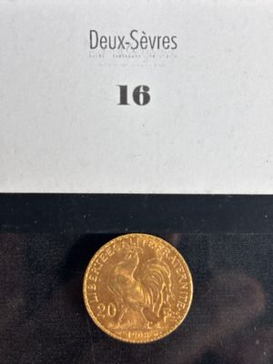 a close up of a gold coin on a black surface