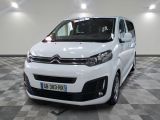 the white van is parked in a large room with a checkered floor