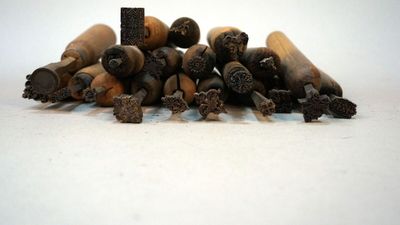 a pile of cigarettes sitting on top of a white table