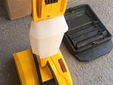 a yellow and white machine that is on the ground