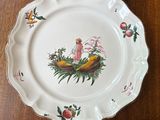 a plate with a picture of a girl on it on a table