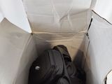 a bag of luggage sitting inside of a cardboard box