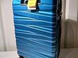 a blue suitcase with a tag on it sitting on a table