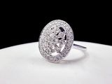 a white plate with a diamond ring on top of it