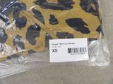 a yellow and black leopard print shirt in a plastic bag