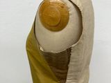 beige and green dress with a wooden button on the back