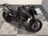 a picture of a black motorcycle parked on a checkered floor