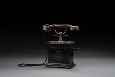an old fashioned telephone on a black background with a black background
