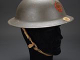 a silver helmet on a mannequin head on a black background