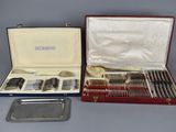 a case with silverware in it and a tray with silverware in it