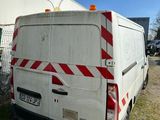 a white van that is parked in front of a building