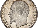 a silver coin with a man ' s face on it