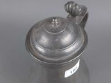 an antique silver teapot with a handle and a lid