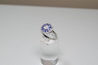a ring with a tan and white diamond on top of it