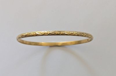 gros plan d'une bague en or sur une surface blanche