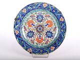 an image of a blue and orange plate sitting on top of a white table