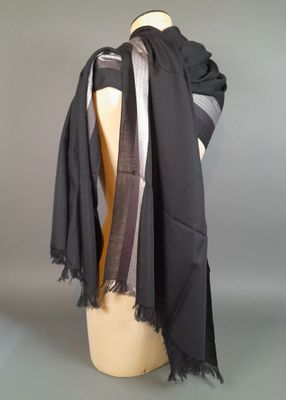grey and black scarf on a mannequin head on a mannequin head