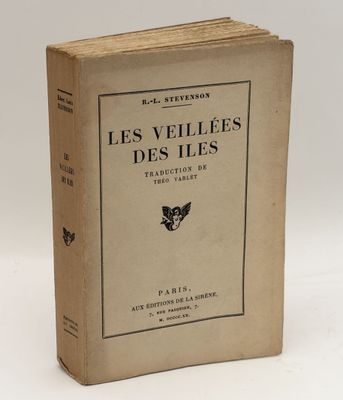 an old book sitting on top of a table next to a white wall