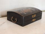 a small black suitcase sitting on a marble counter